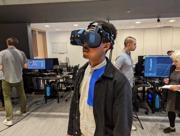 ODL fellow Kidus Hailesilassie wearing a large and futuristid-looking mixed reality headset in the Immersion Lab.